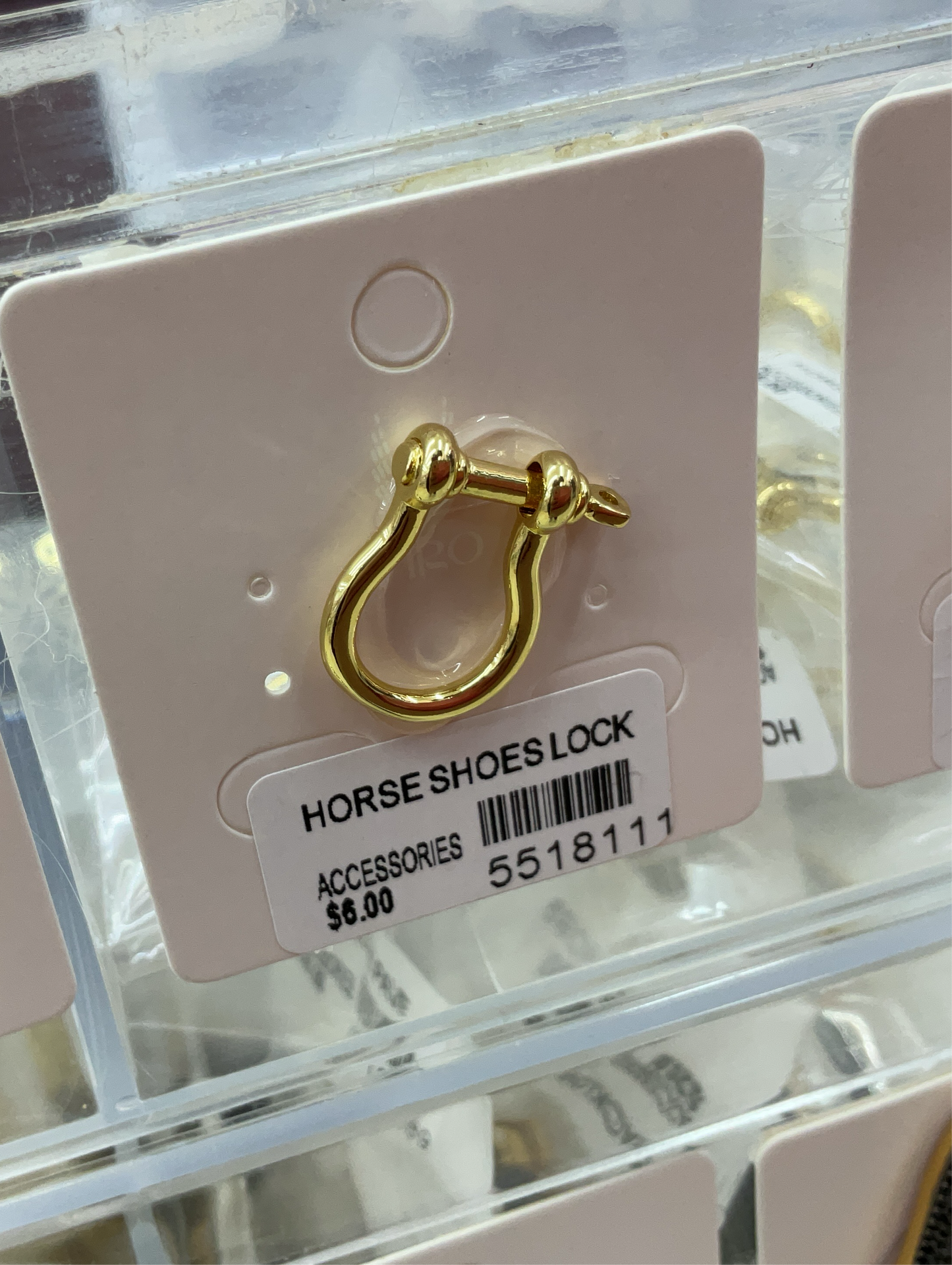 Gold horse shoes lock accessory on white display card with price tag $6.00 in clear retail packaging