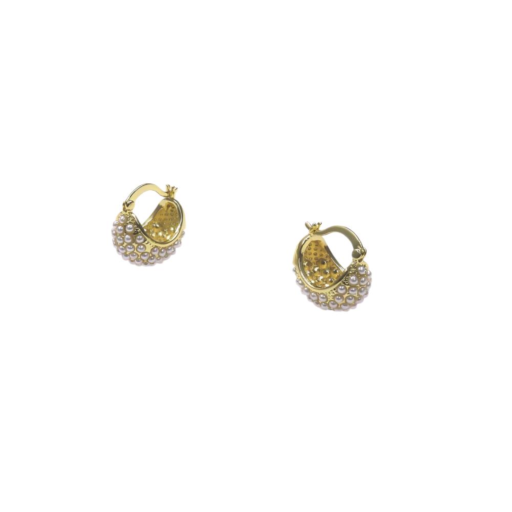 Gold huggie earrings adorned with chunky pearls for an elegant modern look.