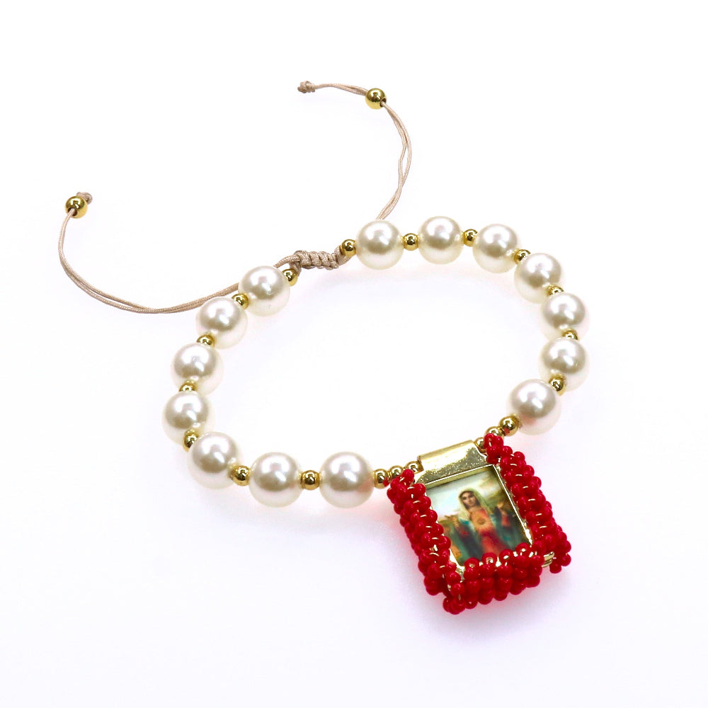 Adjustable pearl bracelet with gold accents and red beaded religious escapulario charm