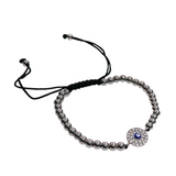 Small evil eye bracelet with silver beads and adjustable black slider cord featuring a silver circle eye charm