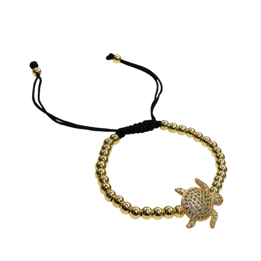 Gold beaded adjustable slider bracelet with a sparkling tortoise charm