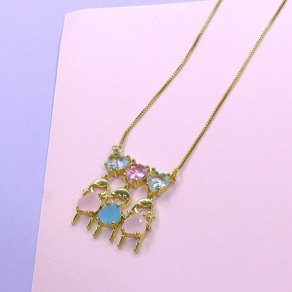 Gold kids chain necklace with colorful family charms on pink and purple background