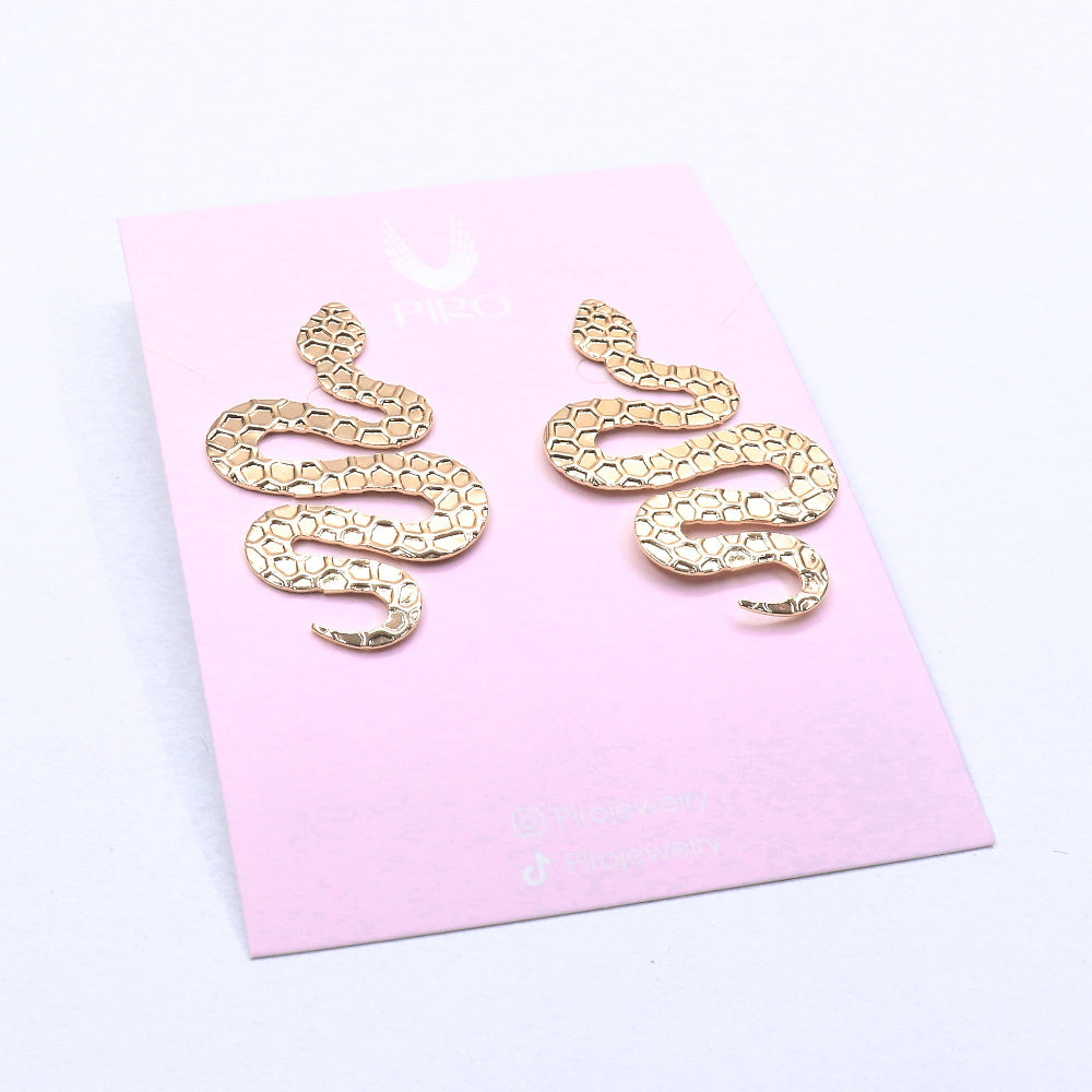 Gold fill SNAKE EARRING with textured scale design on a pink card