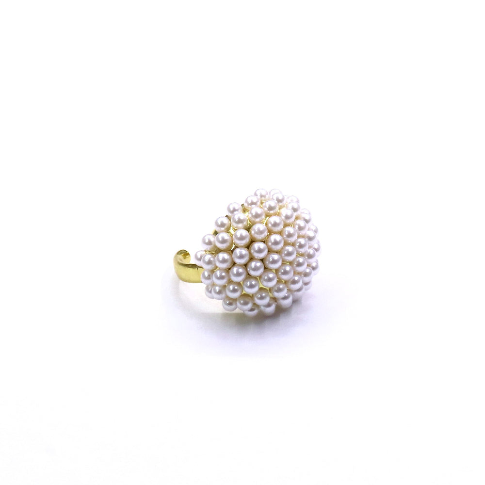 Pearl beaded ring with gold band on a white background