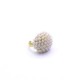 Pearl beaded ring with gold band on a white background