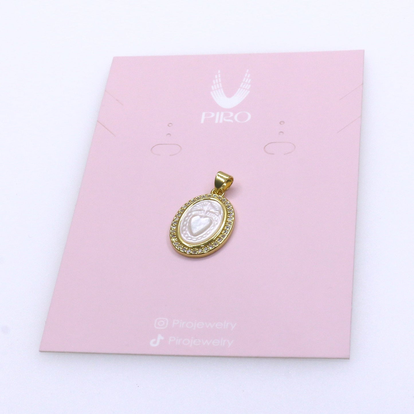 Gold and white natural shell love pendant on pink Pro jewelry card