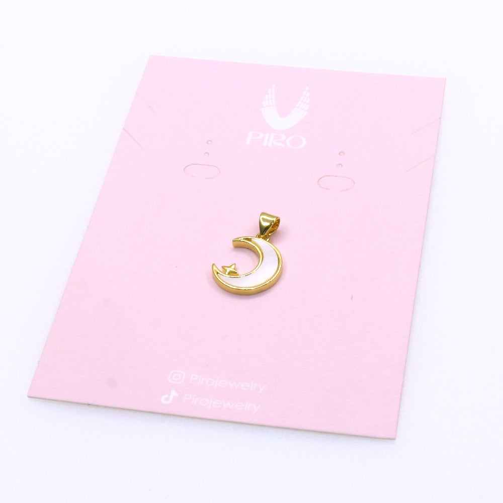 Gold NACAR moon and star charm pendant on a pink display card