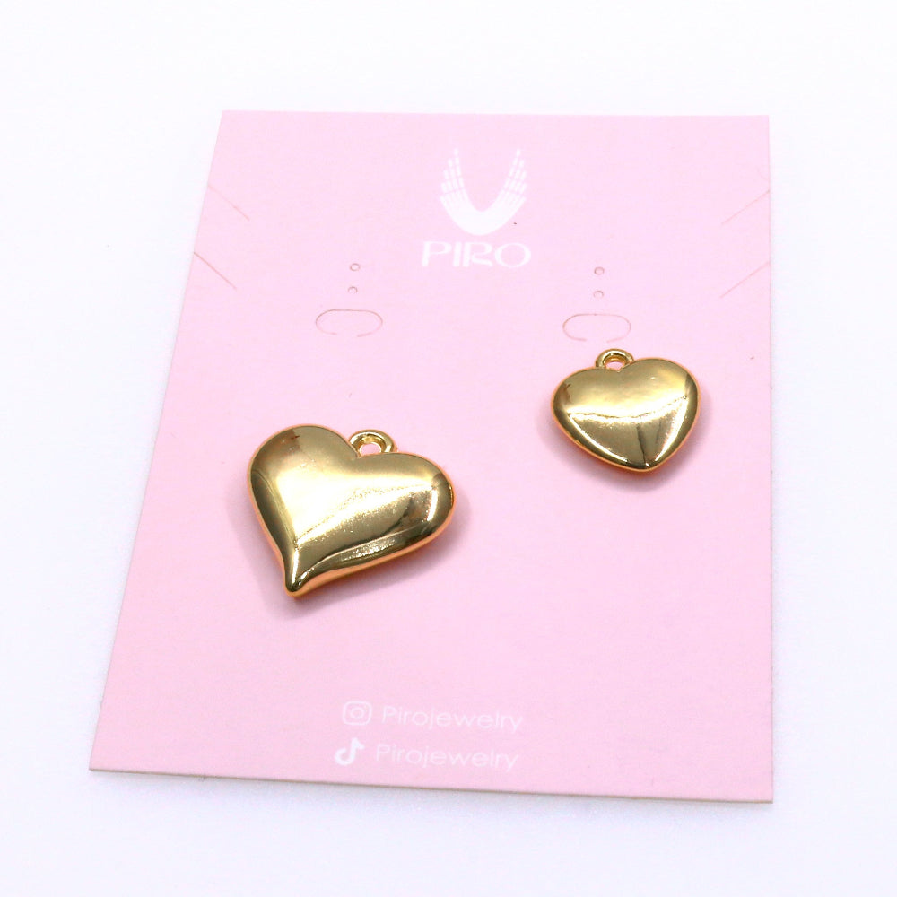 Two gold heart-shaped charms on a pink jewelry card with delicate design and high-quality finish