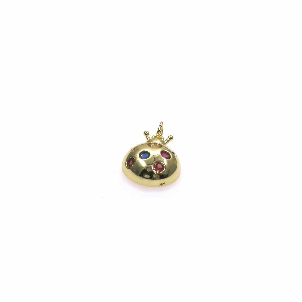Gold ladybug charm with multi-color stones and intricate design on white background