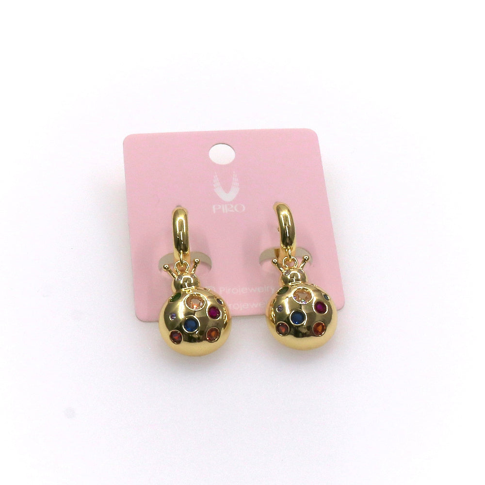 Gold ladybug earrings with colorful gemstone spots on pink display card