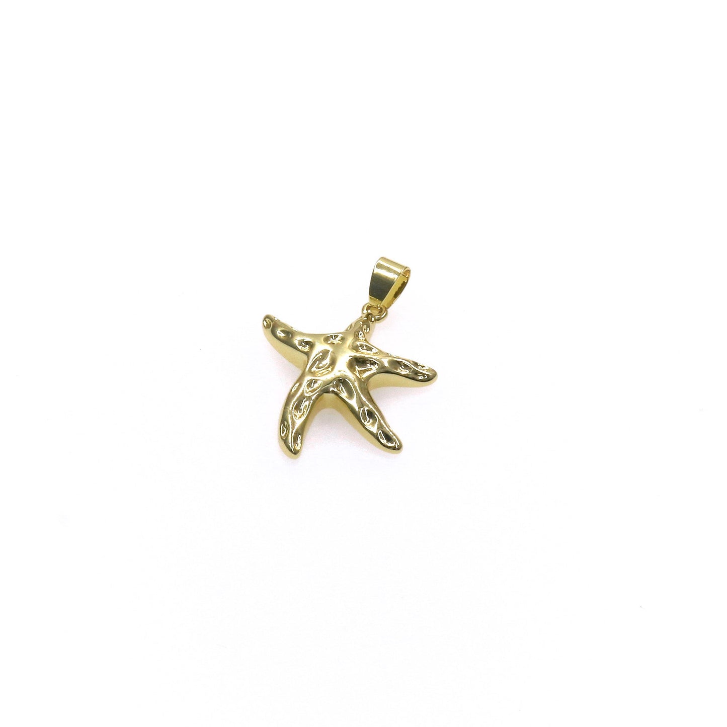 Gold sea star charm pendant with intricate design on white background