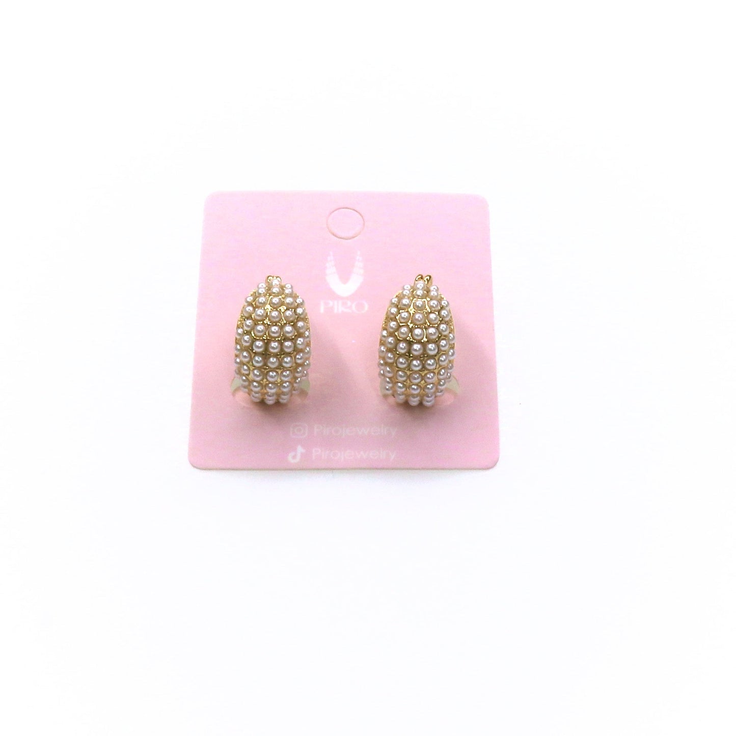 Elegant PEARLS HUGGIE earrings with delicate pearls on a pink display card
