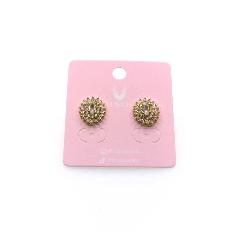 Gold pave stud earrings with sparkling stones on pink display card
