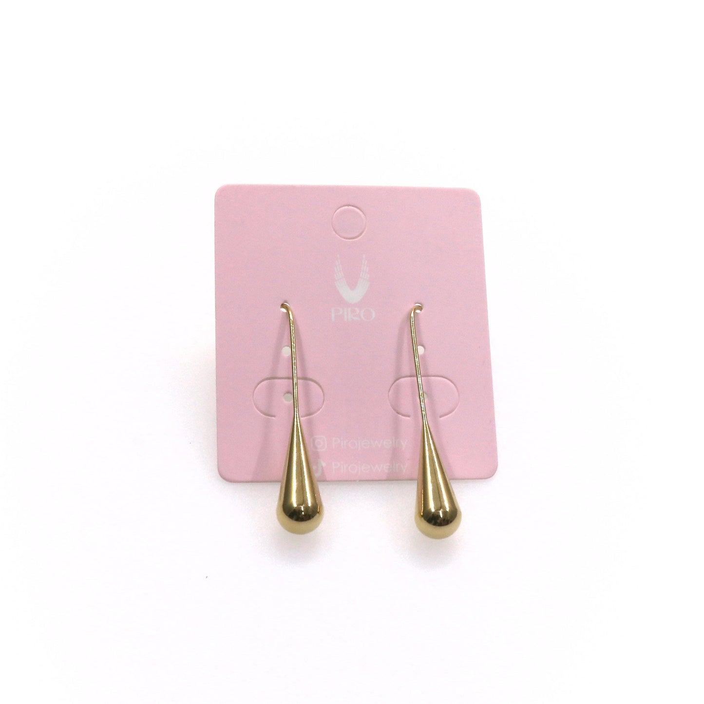 Pair of elegant long drop gold-tone earrings on a pink display card