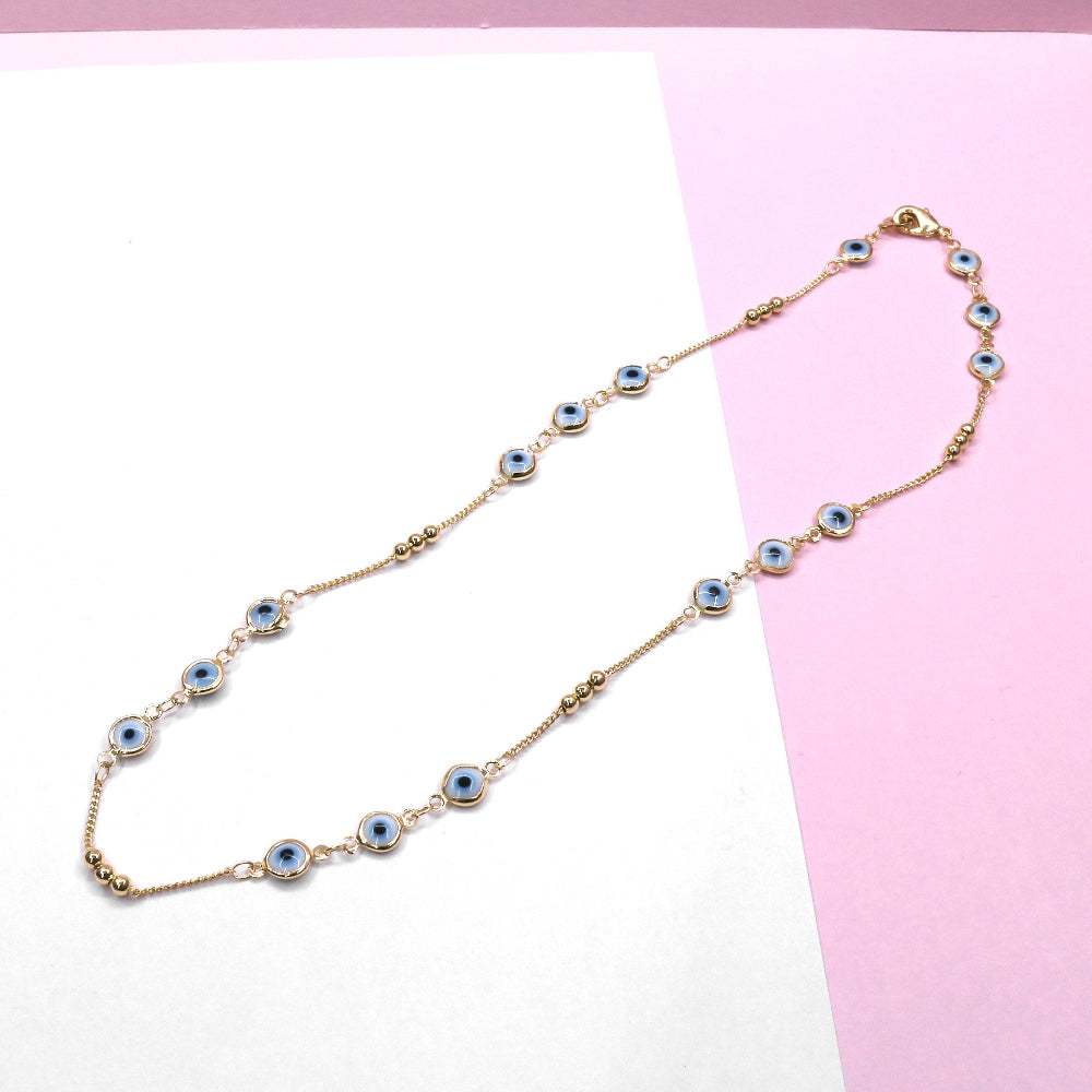 Elegant WHITE EYE CHAIN with blue eye charms and gold-tone links on a pink and white background