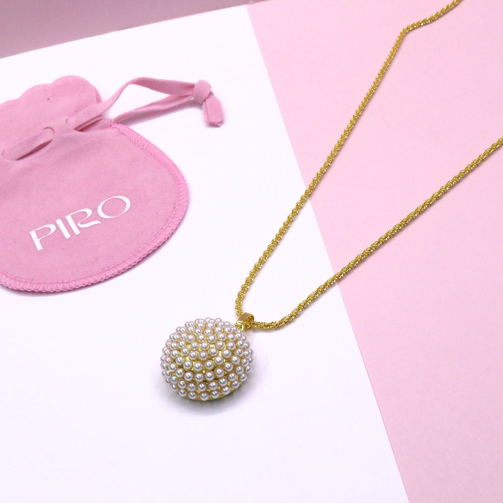 Gold chain necklace with a circular pearl cluster pendant and pink jewelry pouch