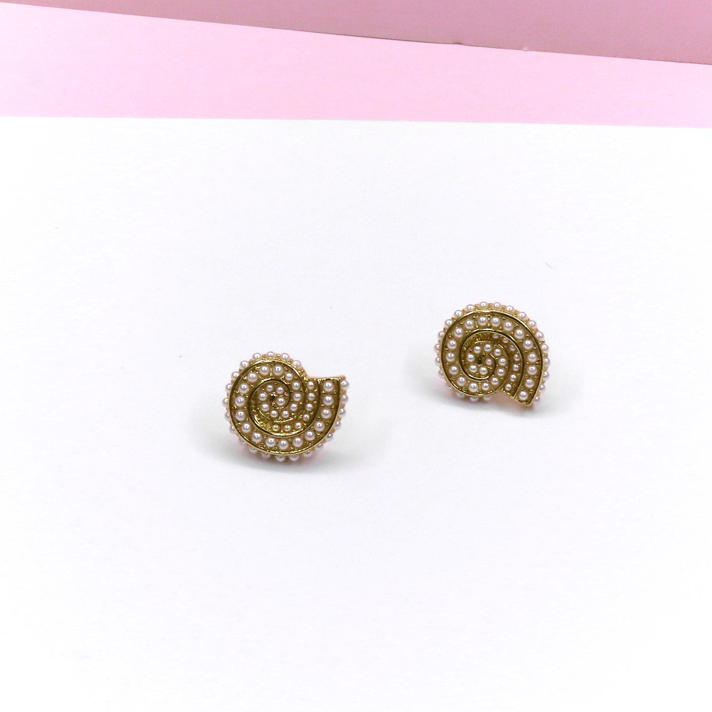 Ocean snail-shaped earrings adorned with delicate ocean pearls, handcrafted for a stylish and elegant look.