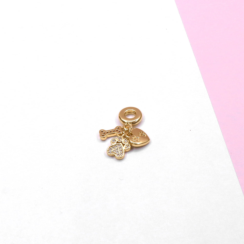 Gold I LOVE MY DOG CHARM with bone, paw, and heart pendants on white and pink background