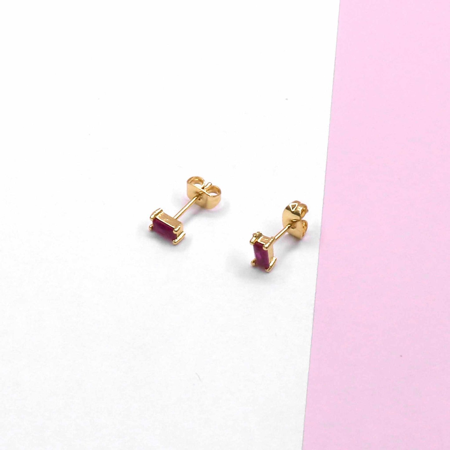 MINI SQUARE STUD earrings with modern design on white and pink background.