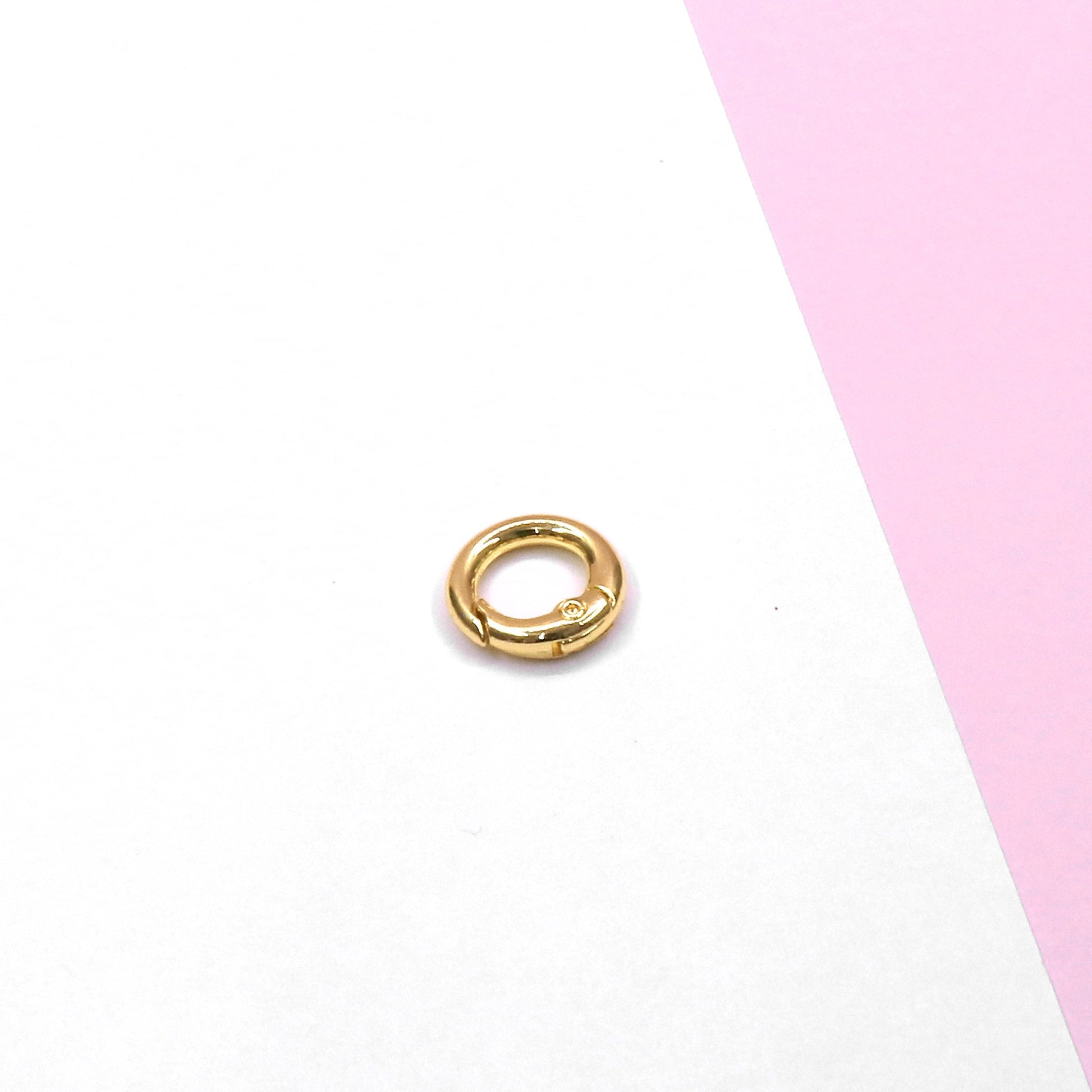 Gold lock accessory part on white and pink background enhancing lock durability and security