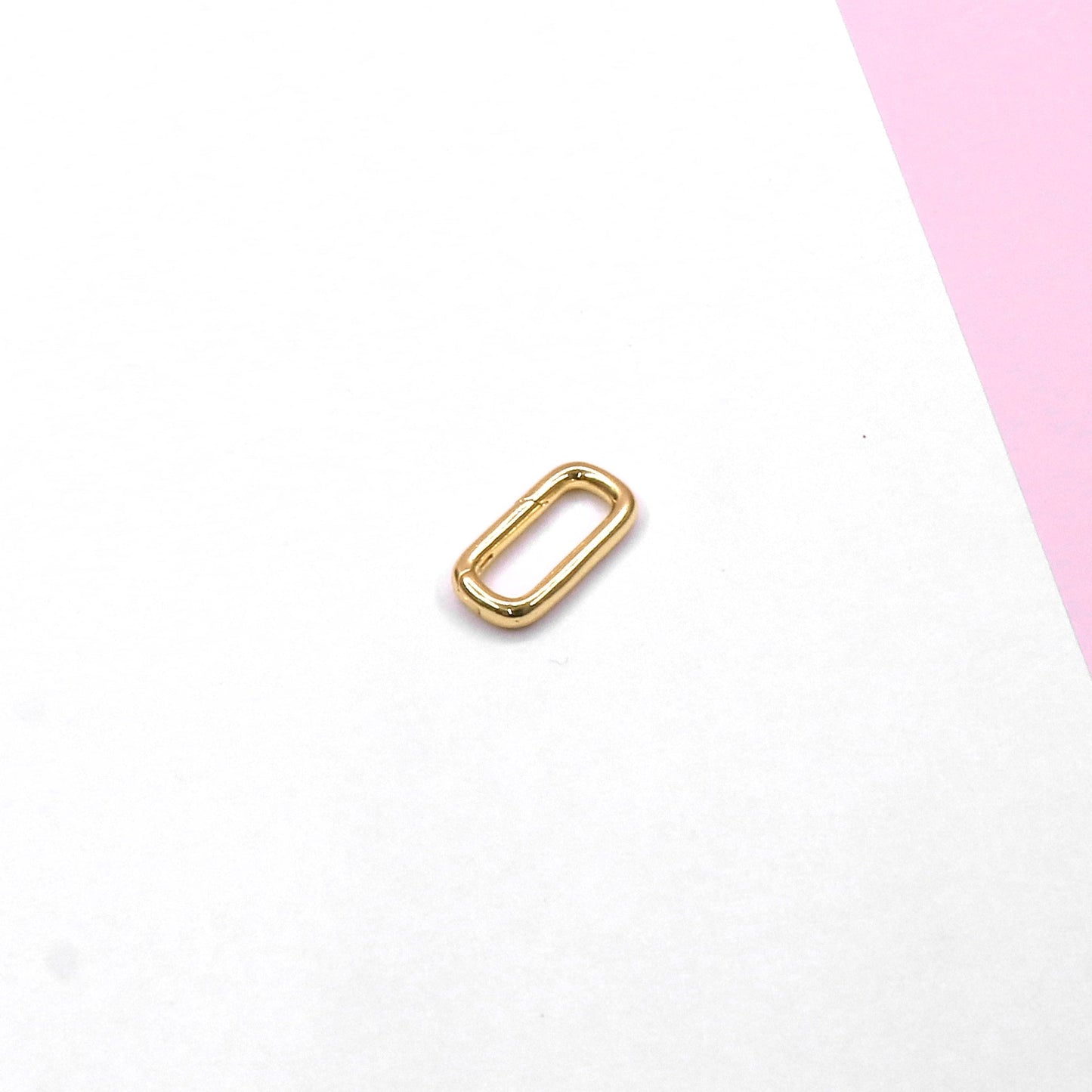 Small gold lock accessories part on white and pink background