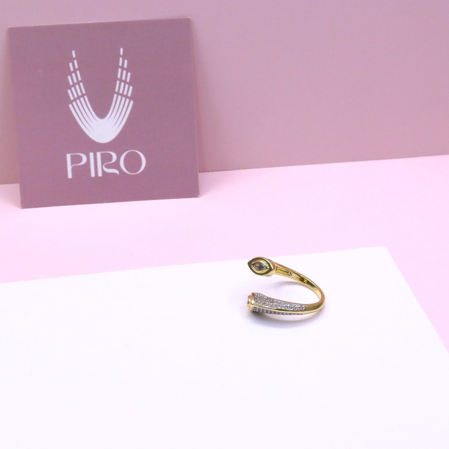 Adjustable SHINE PAVE RING with pave design and gold finish on white and pink background