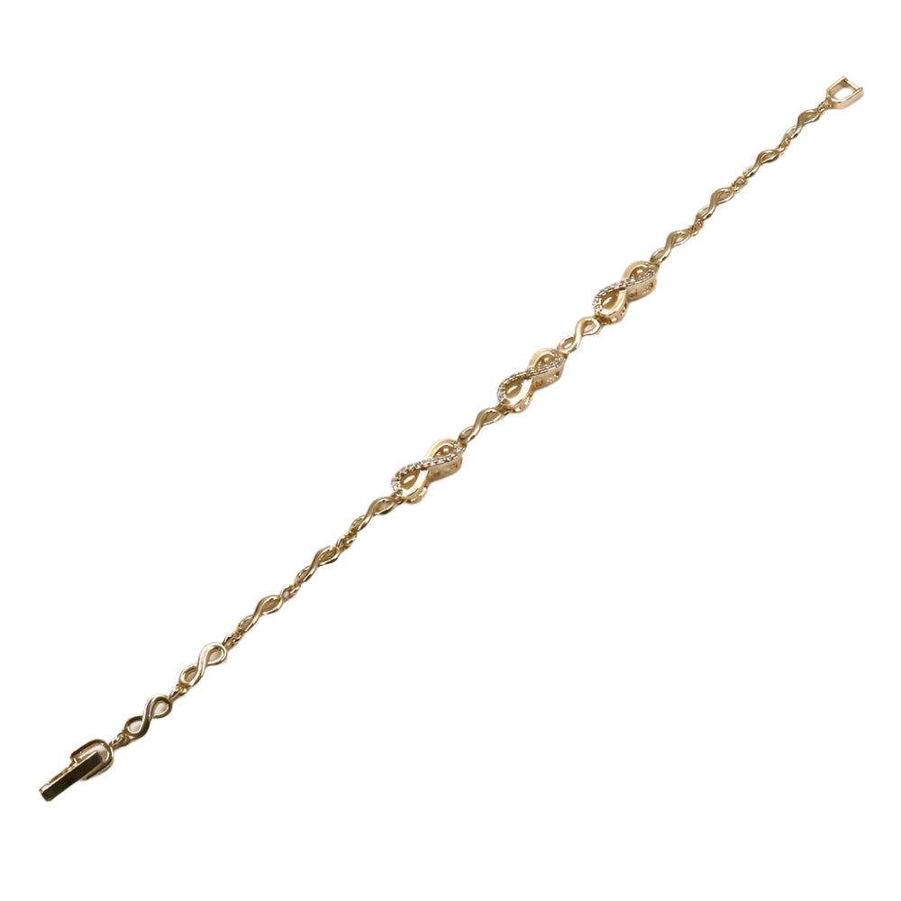 Gold bracelet on a light purple background