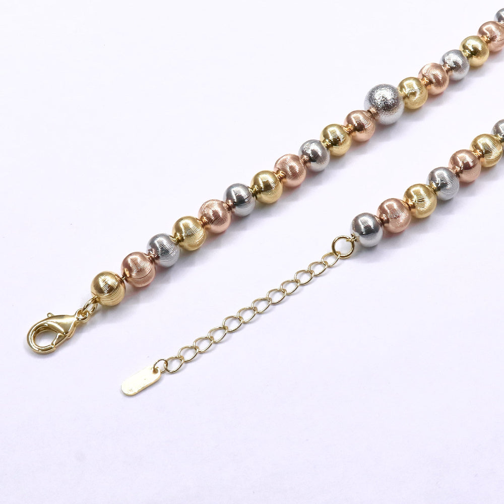 Multicolored beaded necklace with a gold clasp on a light pink background