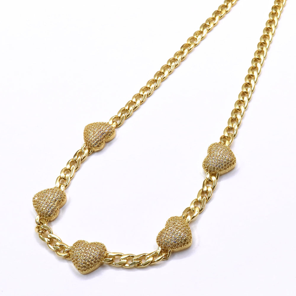 Gold necklace with heart-shaped pendants on a white background