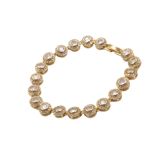 Gold bracelet with clear stones on a white background