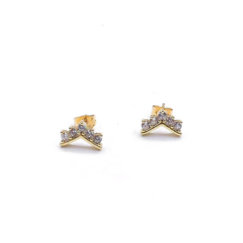 Gold bow-shaped earrings with clear stones on a white background