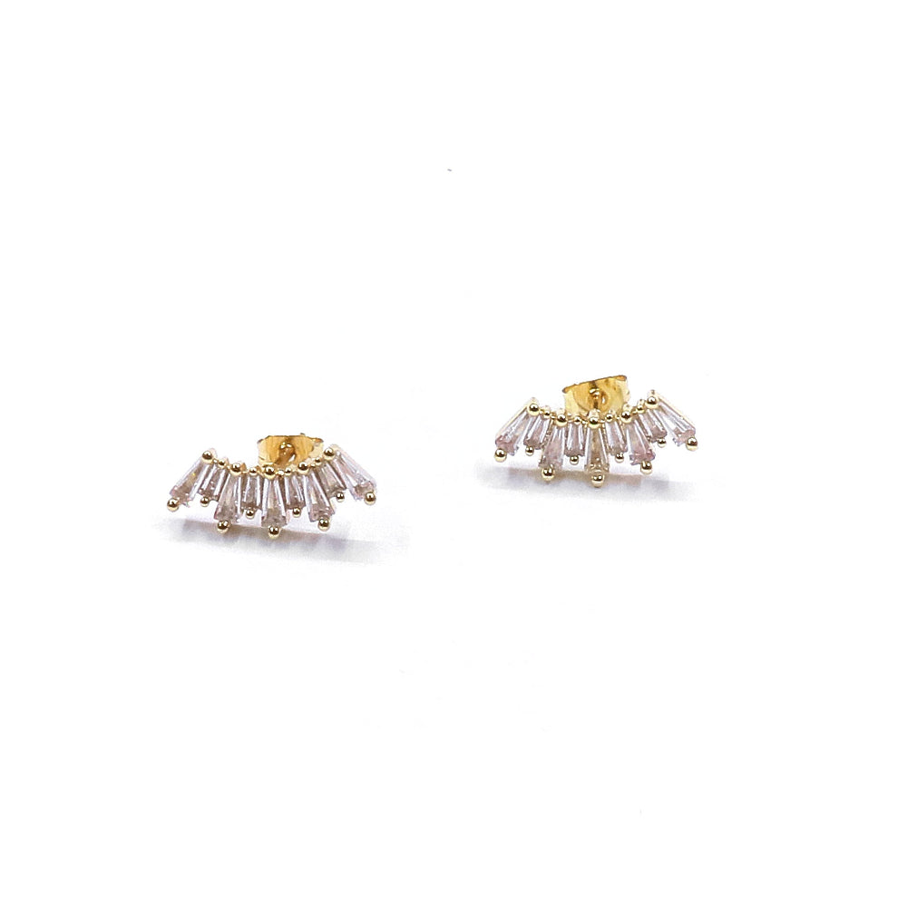 Gold and clear gemstone earrings on a white background