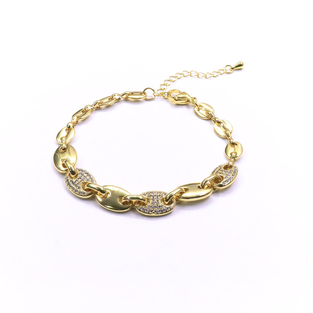 Gold chain bracelet with heart-shaped links on a white background