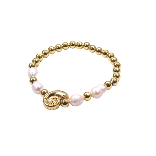 Gold and pearl bracelet on a white background