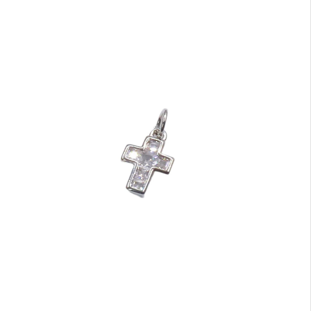 Silver cross pendant with clear stones on a white background