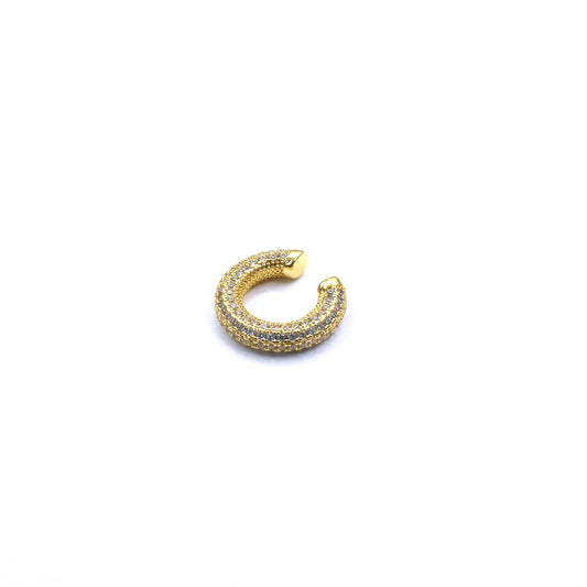 Gold earring with embedded stones on a white background
