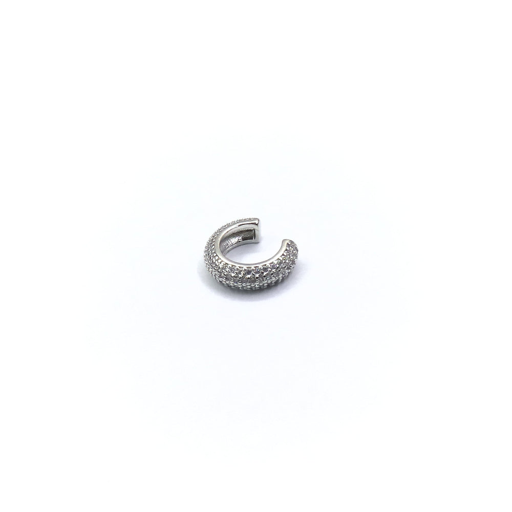 Silver earring with small stones on a white background