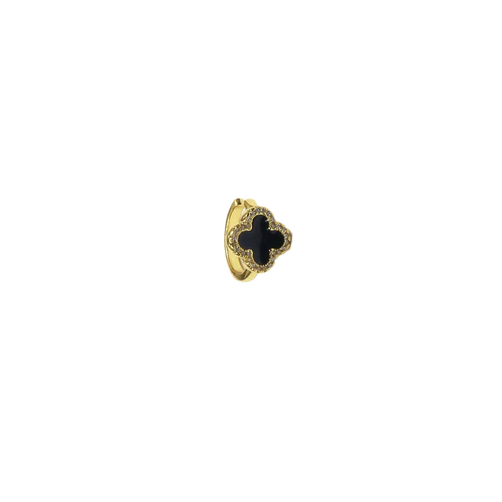 Gold ring with a black clover design on a white background