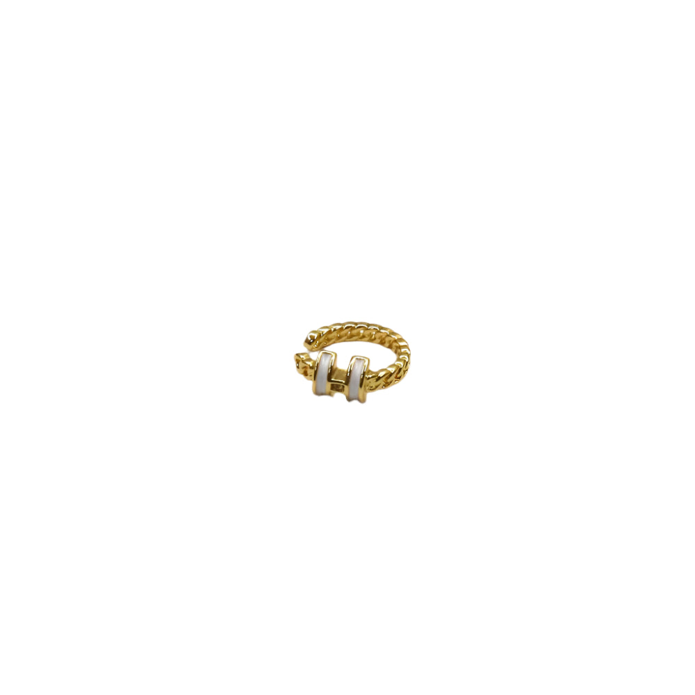 Gold ring with a white stone on a white background
