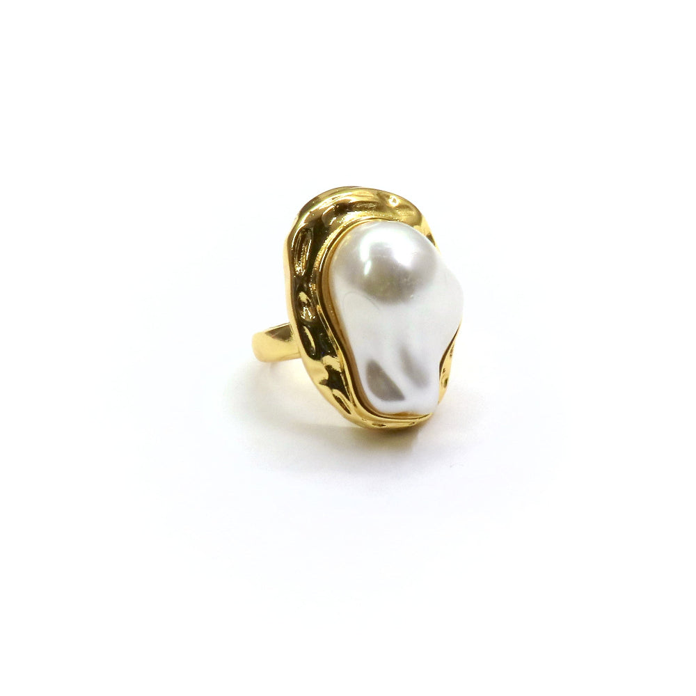 Gold ring with a large white pearl on a white background