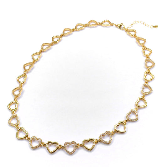 Gold heart-shaped necklace on a white background