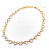 Gold heart-shaped necklace on a white background