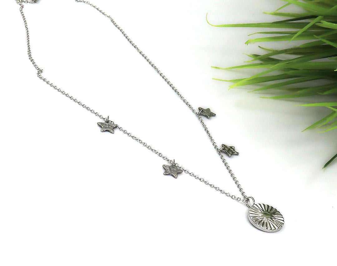 Delicate silver Tiny Star Chain necklace with small star charms and round sunburst pendant on a fine chain.