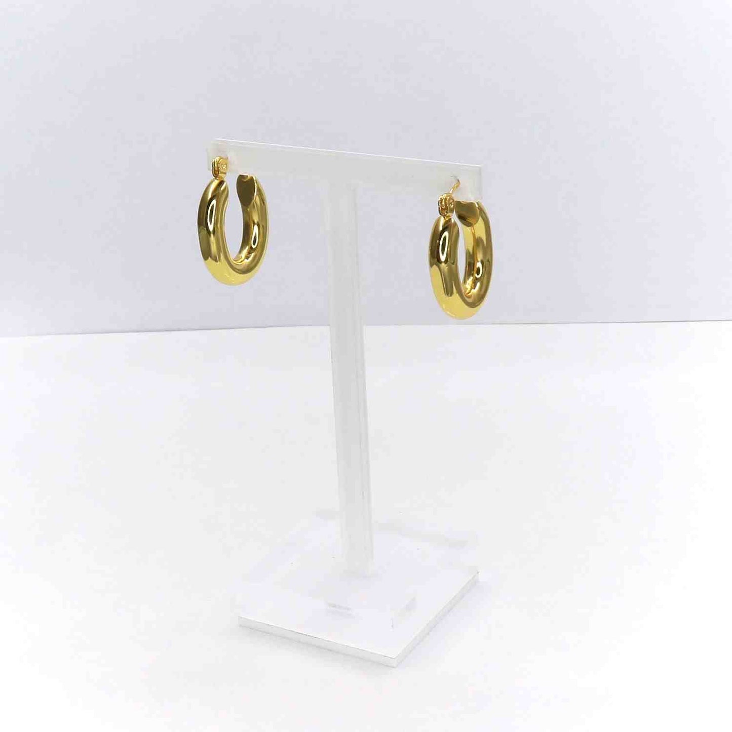 Gold oval earrings on display stand, crafted from high-grade stainless steel.
