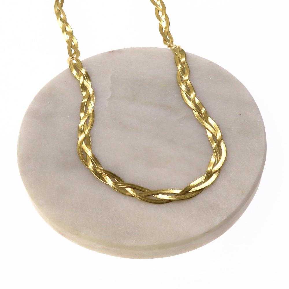 Gold tangled chain necklace with intricate twisted design on round beige stone display