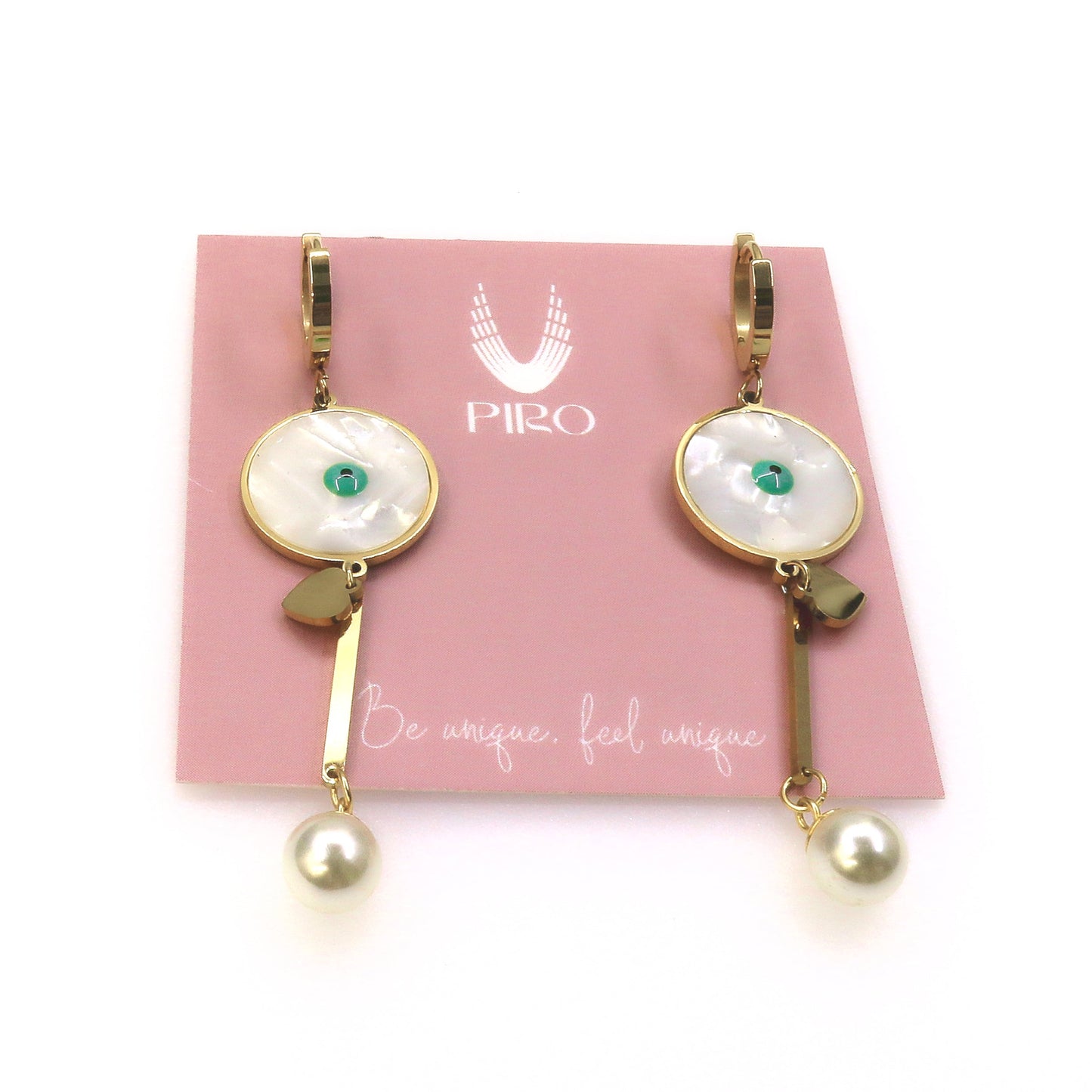 Gold Sabina earrings with pearl dangle and mother-of-pearl accents on pink card