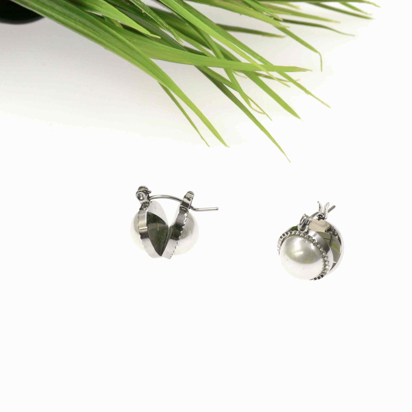 Pearl earrings with stainless steel accents in a modern design.