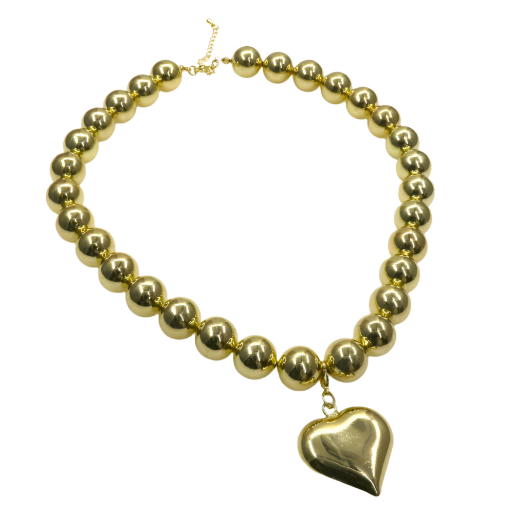 Chunky gold bead necklace with heart-shaped charm pendant.