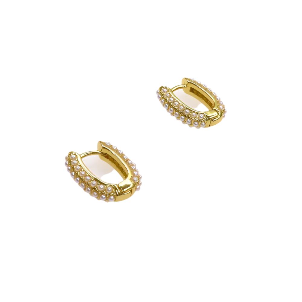 Gold huggie earrings adorned with genuine oval pearls on a white background