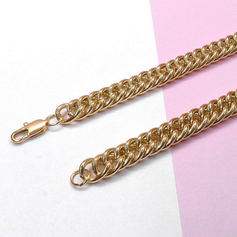 Chunky Havana necklace with close Cuban link chain in gold tone on pink and white background